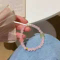 Detailed view of the sweet pink crystal beaded bracelet with pearls and green stone. - Cream Sugar Cube