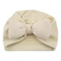 Beige baby knot turban hat with a big bow, soft solid color infant cap for cute daily wear. - One Size / Beige