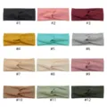 Detailed view of twisted cross headbands in various colors, diamond lattice stretch fabric. - Multicolor
