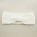 White knitted headband for women, cozy winter ear warmer with bow design, trendy hair accessory. - White