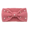 Close-up detail view of the pink knitted wool headband featuring elegant white pearls and bow. - Dusty Pink