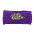 Detailed shot of purple knitted winter headband with elegant beaded crystal leaf embellishment. - Purple