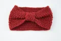 Red knitted headband for women, cozy winter ear warmer with bow knot, soft hair accessory. - Wine Red