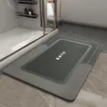 Detailed view of a minimalist grey absorbent bathroom floor mat with non-slip backing for home toilet. - HOME-Black