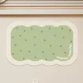 Detailed view of cute scalloped green bath mat featuring stylish polka dots and text. - Vanilla Soda Biscuit Irregular