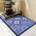 Detailaufnahme der blau-weißen Küchen-Abtropfmatte mit Fliesenmuster unter Kaffeemaschine. - Blatte Farbige Fliese