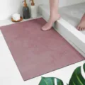 Detail view of soft absorbent bathroom mat in chic pink, perfect for modern home decor. - Cement Dark Pink