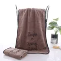 Soft brown microfiber bath towel with stylish print text, highly absorbent for home use. - Face Towel / Coffee