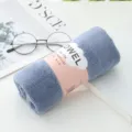 Soft absorbent coral fleece face towel in solid blue color with belly band packaging - Grey Blue
