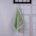 Solid color coral velvet hanging towel with white piping and small label for daily use. - Green