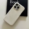 Detail view of a minimalist solid color textured phone case, offering a sleek look and reliable protection. - White / iPhone 11