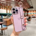 Purple electroplated heart wrist strap phone case, elegant soft protective cover for phone. - Electroplated Hollow Heart + Blank Wristband / Taro Purple / iPhone 14 Pro Max