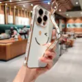 Luxury electroplated white phone case with cute smile pattern and wrist strap for iPhone. - iPhone 14 Pro Max / Ivory
