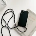 Detailed view of black silicone phone case with adjustable black white lanyard strap design. - Black / iPhone 13