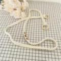 Handmade woven cotton yoga mat strap sling carrier with wooden rings and beads detail view. - Style 3