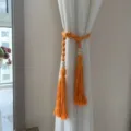 Boho orange macrame curtain tieback with wooden beads and tassels, handmade cotton rope holdback. - Orange