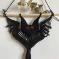 Handmade black macrame bat wall hanging with red eyes, cute Halloween woven decor for room. - Style 2