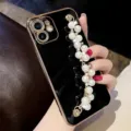 Close-up detail of luxury black electroplated phone case with elegant pearl bracelet strap. - iPhone13MINI / Back Cover / Double Row Pearls (Wrist Strap Accessory) / Electroplated Black