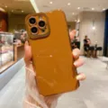 Detailed view of the glossy electroplated phone case held in hand, showing fine camera cutout. - Red / iphone13