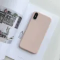 Silicone phone case detail shot, matte pink finish, precise camera cutout, lifestyle setup. - Pink