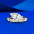 Gedetailleerd close-up van een markies geslepen diamantring met stralende stenen. - Maat 5 / Goud