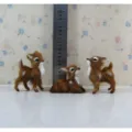 Detailed view of miniature faux fur deer figurines with size scale ruler for display. - Three Small Deer