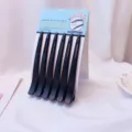 Close up detail of seamless hair clips in matte black duckbill style on packaging card. - 6 Pieces/Pack / Black