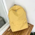 Zaino giallo minimalista da donna, borsa scolastica casual monocolore per uso quotidiano - Giallo