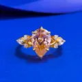 Detail view of S925 silver pear padparadscha ring with sparkling side stones for elegant look. - Size 5 / Padparadscha Pink