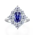Elegant 925 sterling silver ring featuring an oval blue sapphire haloed with sparkling diamonds. - Size 5 / R190 Blue Rhinestone
