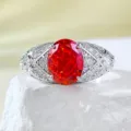 Close-up of 7x9mm oval sunset orange high-carbon diamond ring with pave side stones in silver. - Size 5 / R974 Sunset Orange