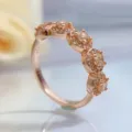 Close-up detail of multi-stone halo rose gold ring with sparkling champagne stones. - Size 5 / Rose Gold