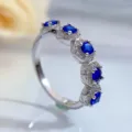 Detailed close-up of a stunning S925 silver ring with blue oval stones and sparkling pavé diamonds. - Size 5 / Blue