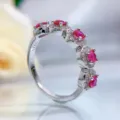 Detailed close-up of a stunning S925 sterling silver ruby ring with sparkling pave cubic zirconia. - Size 5 / Red