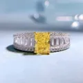 Close-up radiant cut yellow diamond ring with baguette side stones and pave band details - Size 5 / Yellow