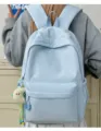 Detail view of the light blue casual backpack with embroidery and cute pendant for daily use. - With Pendant / Blue
