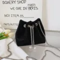 Black rhinestone bucket bag with sparkling crystals, metal chain and pearl drawstring. - Black