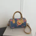 Stylish denim barrel shoulder bag with cute red cherry print, brown handle and strap. - Dark Blue Cherry