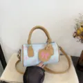 Casual denim pillow handbag in light blue with pink bow print and brown leather handles. - Light Blue Bowknot