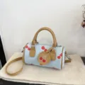 Chic denim cherry print barrel bag, stylish brown leather handle crossbody shoulder bag variant. - Light Blue Cherry