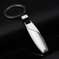 Sleek metal and leather car keychain with teardrop pendant and sturdy ring variant. - Silver