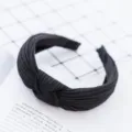 Detailed view of a black pleated knot headband, vintage fabric hair hoop for daily wear. - Black