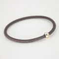 Minimalist brown hair tie variant featuring a sleek metallic gold bead for daily wear. - Coffee