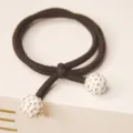 Black elastic hair tie featuring dual white rhinestone ball ends, chic hair accessory detail. - White Rhinestone Ball