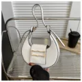White crescent shoulder bag detail, stylish PU leather underarm handbag with gold buckle. - White