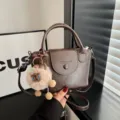 Dark brown leather crossbody handbag with cute plush keychain, retro style top handle bag for women. - Coffee With Pendant