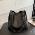 Black PU leather bucket bag with knotted shoulder strap, stylish minimalist tote bag for women. - Black
