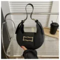 Chic black crescent underarm bag for women, trendy leather shoulder hobo handbag with metal buckle. - Black