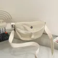 Minimalist beige nylon dumpling crossbody bag, casual everyday commuter shoulder bag for women. - Off White