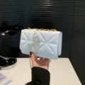 White quilted chain shoulder bag for women, stylish crossbody bag with gold tone hardware. - White